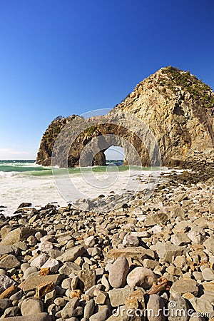 Natural arch on the rocky coastline of Izu Peninsula, Japan Stock Photo